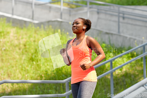 Image of african american woman running outdoors