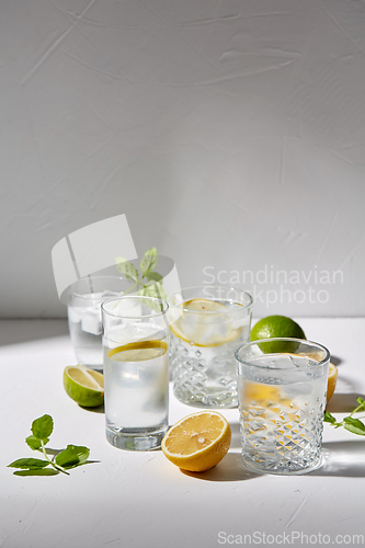 Image of glasses with lemon water and peppermint on table