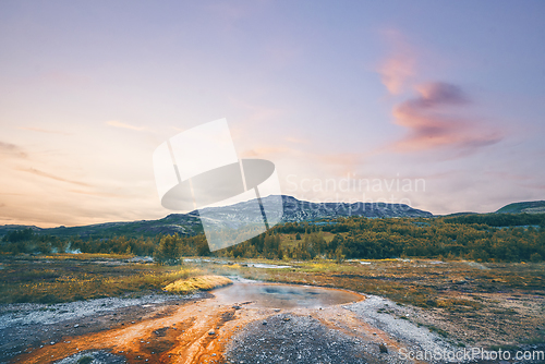 Image of Steamy river with a geyser basin