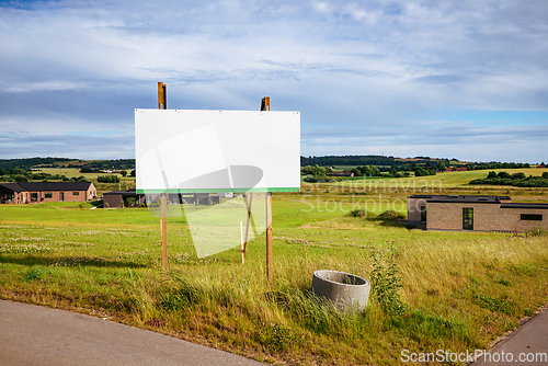 Image of Large billboard sign on a green field