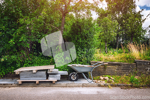 Image of Wheelbarrow with tiles on a street