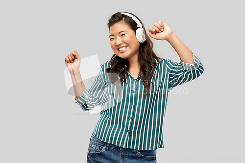 Image of asian woman in headphones listening to music