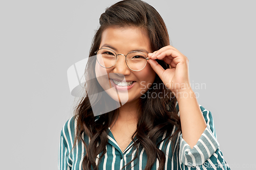 Image of portrait of happy asian woman in glasses