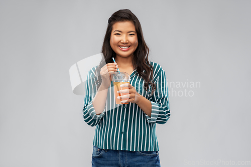 Image of asian woman with juice in plastic cup with straw