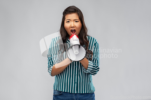 Image of angry young asian woman speaking to megaphone