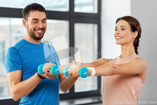 Image of happy couple exercising at home