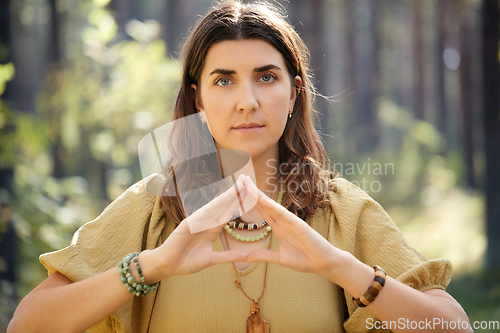 Image of woman or witch performing magic ritual in forest