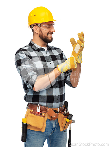 Image of happy male worker or builder in helmet and gloves