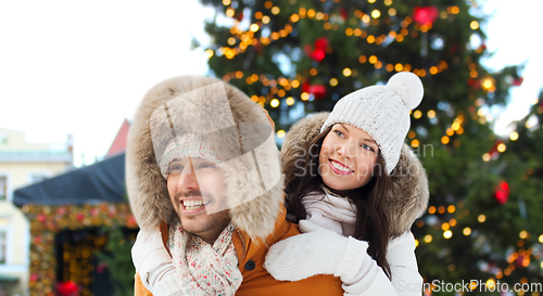 Image of happy couple over christmas market background