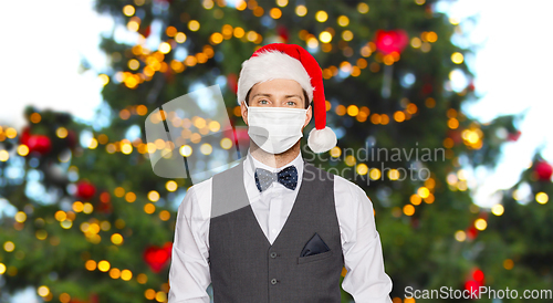 Image of man in protective masks and santa hat on christmas