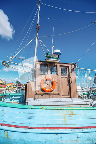 Image of Retro old fishing boat in a marine harbor