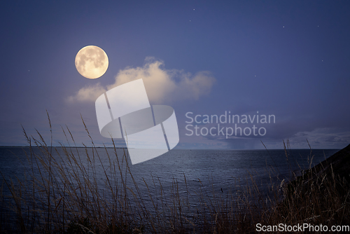 Image of Full moon over the sea with sparkling stars