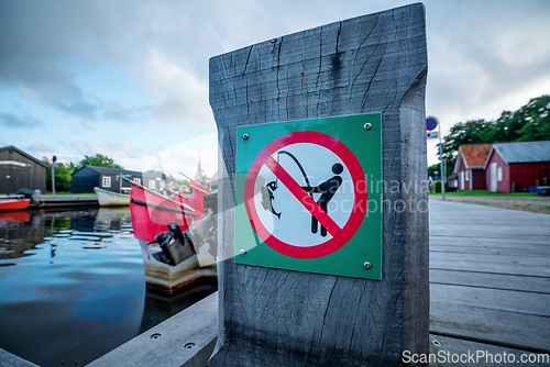 Image of Fishing prohibited sign on a wooden pier