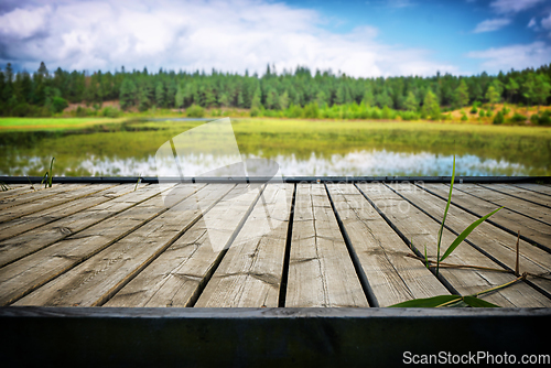 Image of Wooden pier with planks at an idyllic lake