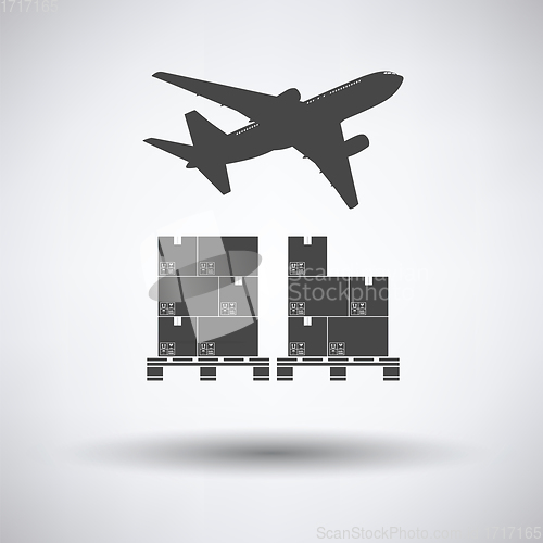 Image of Boxes on pallet under airplane