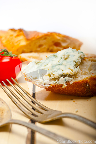 Image of fresh blue cheese spread ove french baguette