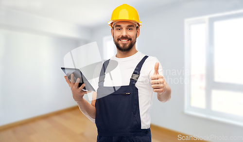 Image of worker or builder with tablet pc showing thumbs up