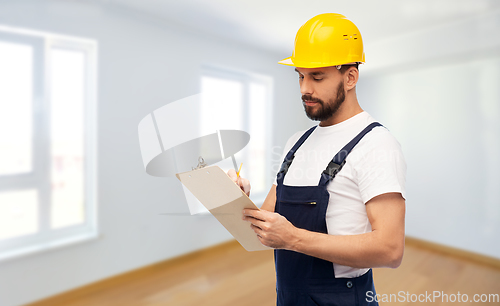 Image of male worker or builder in helmet with clipboard