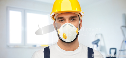 Image of male worker or builder in helmet and respirator