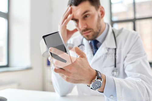 Image of male doctor with smartphone at hospital