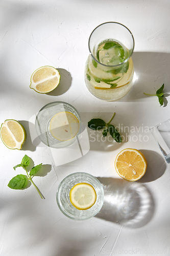 Image of glasses with lemon water and peppermint on table