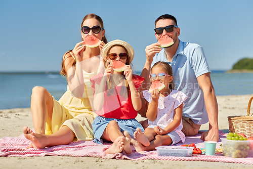 Image of happy family having picnic on summer beach
