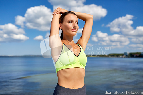 Image of young woman doing sports at seaside