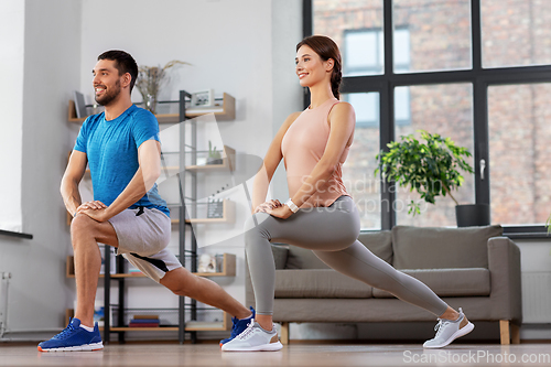 Image of couple exercising and doing lunge at home