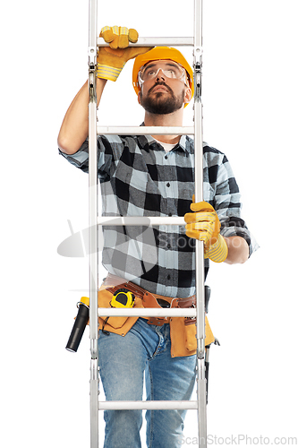 Image of male builder in helmet climbing up ladder