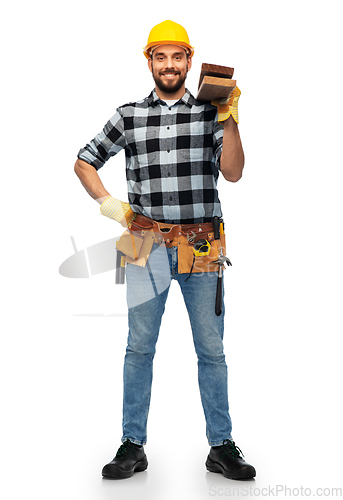 Image of happy male worker or builder in helmet with boards