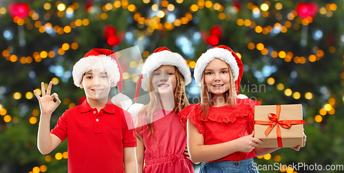 Image of happy smiling children with christmas gift