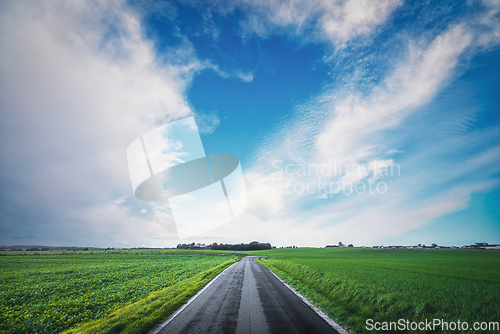 Image of Asphalt road going through a rural landscape