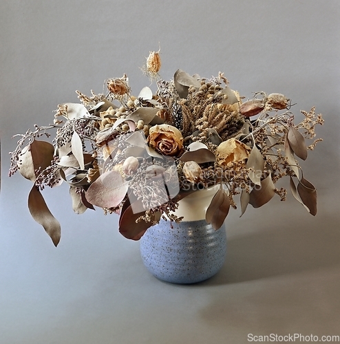 Image of bouquet of dried flowers in ceramic vase