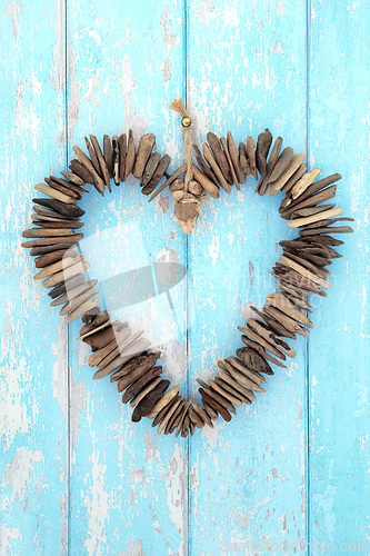 Image of Driftwood Heart Shaped Wreath Sculpture on Rustic Blue Wood 
