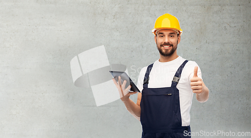 Image of worker or builder with tablet pc showing thumbs up