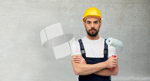 Image of male worker or builder with paint roller