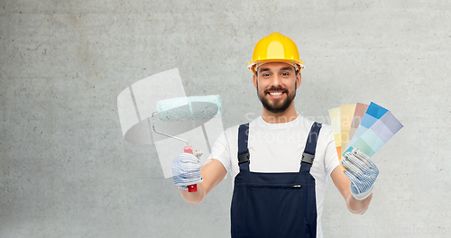 Image of male builder with paint roller and color palettes