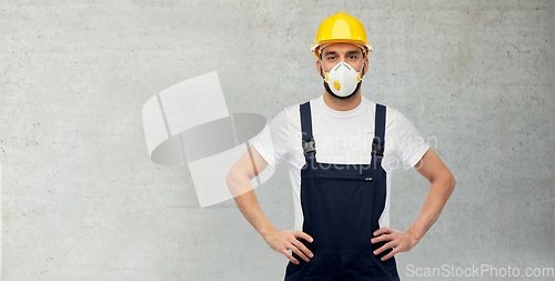 Image of male worker or builder in helmet and respirator