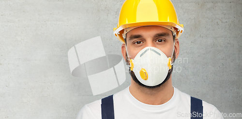 Image of male worker or builder in helmet and respirator