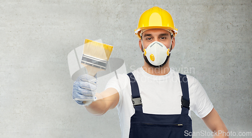 Image of worker or builder in respirator with brush