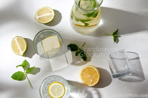 Image of glasses with lemon water and peppermint on table