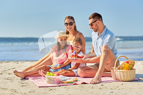 Image of happy family having picnic on summer beach