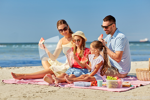 Image of happy family having picnic on summer beach