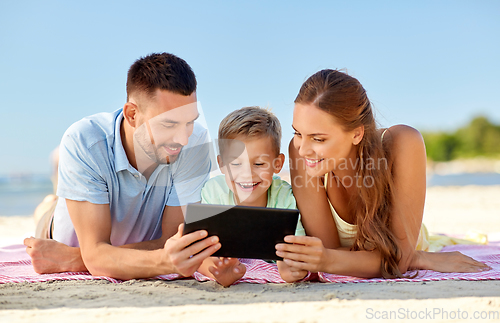 Image of happy family with tablet computer on summer beach