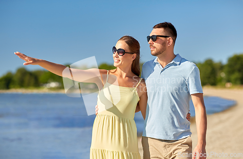 Image of happy couple hugging on summer beach