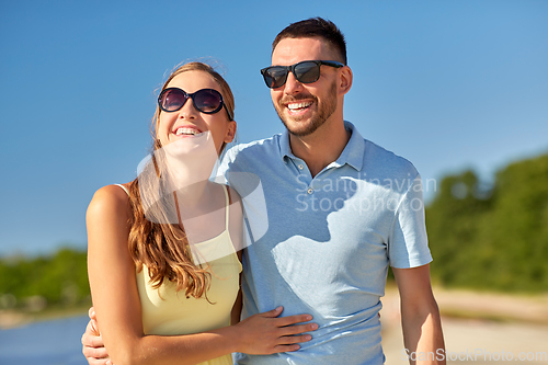 Image of happy couple hugging on summer beach