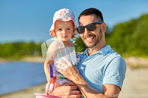 Image of happy father with little daughter on beach