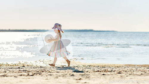 Image of happy baby girl with ball running on summer beach