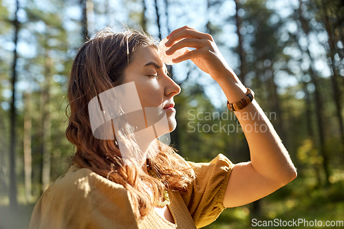 Image of woman or witch performing magic ritual in forest