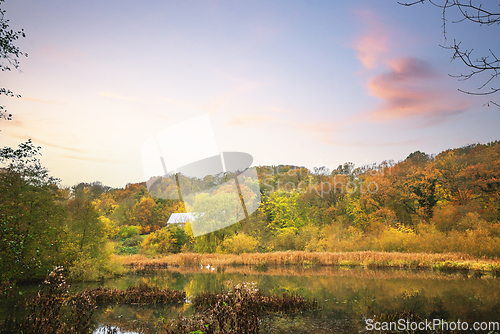 Image of Idyllic lake in a forest with a small cabin